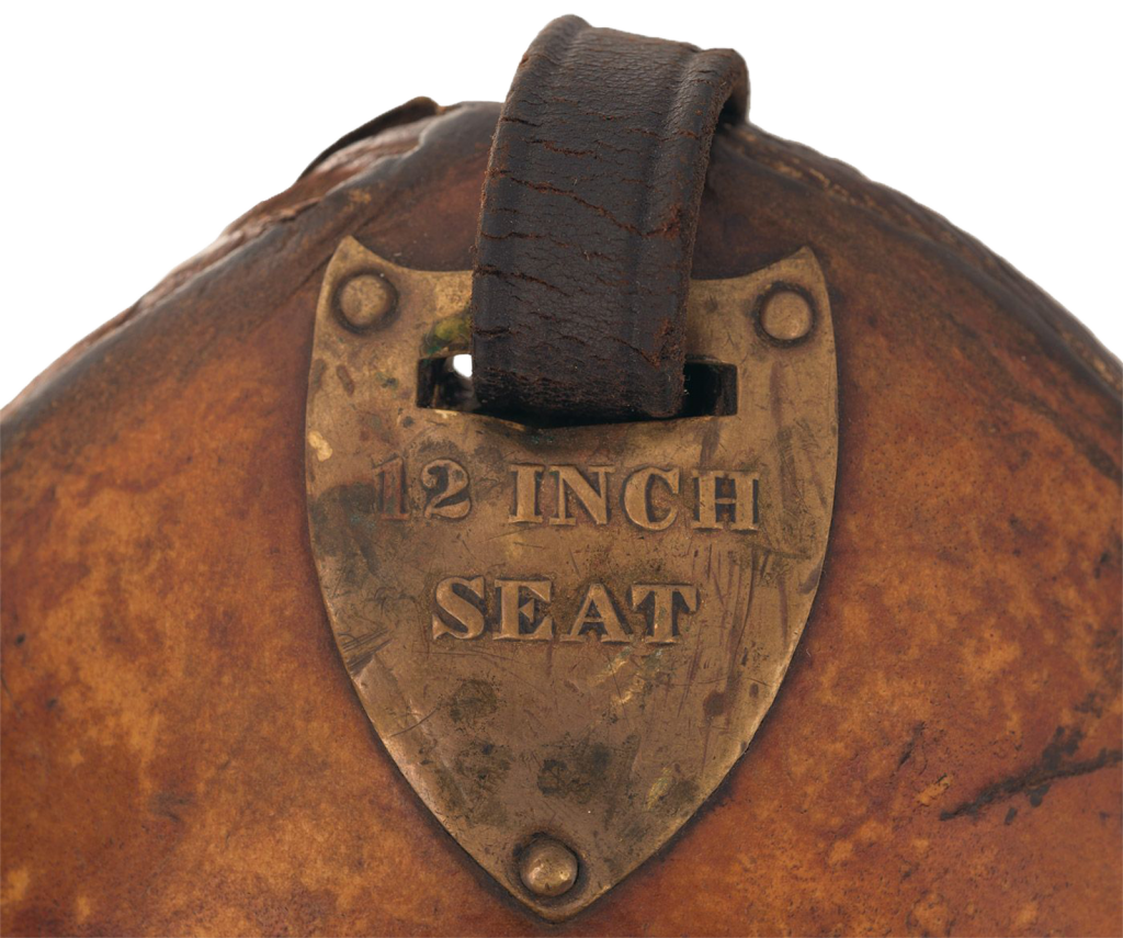 McClellan saddle pommel shield, aged and worn, with 12 inch seat stamped into the medal.