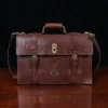 1943 Navigator Briefcase in Vintage Brown Steerhide - front view - on a wood table with a dark background