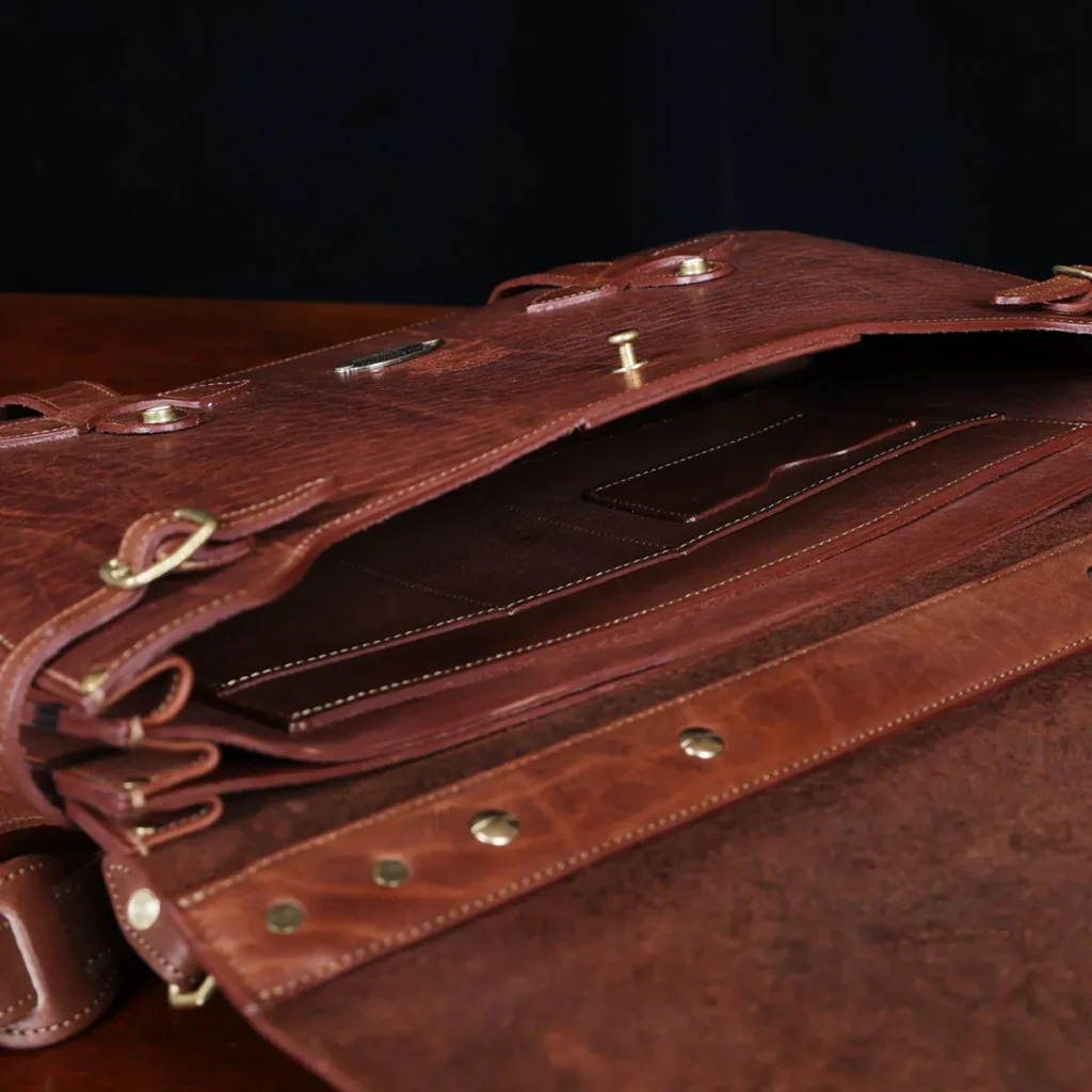 History of the Navigator Briefcase 4 1943 Navigator Briefcase in Vintage Brown Steerhide - open view - on a wood table with a dark background