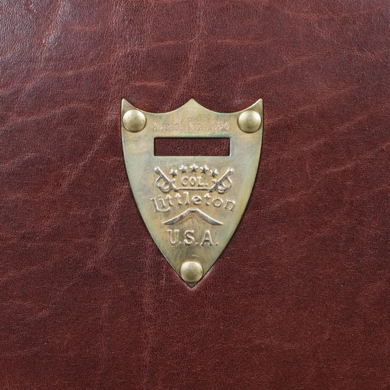 1943 Navigator Briefcase in Vintage Brown Steerhide - pommel view - on a wood table with a dark background