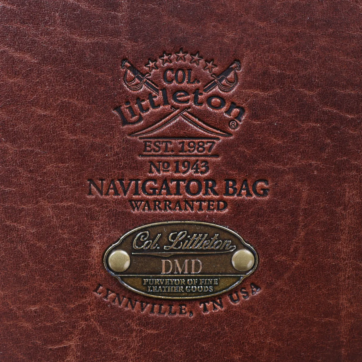 1943 Navigator Briefcase in Vintage Brown Steerhide - stamp view - on a wood table with a dark background
