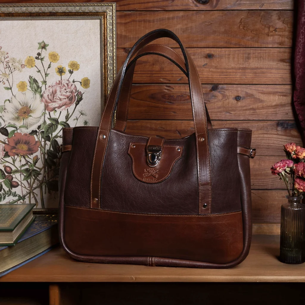 The bentley tote with a floral frame and flowers nearby.