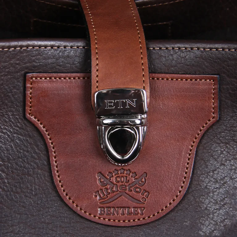 Bentley Tote in dark Tobacco Brown American Buffalo with contrasting vintage brown American Steerhide Trim - close up view of buckle closure with three initial engraving