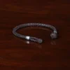 braided brown leather bracelet with pewter beads and loop closure - open