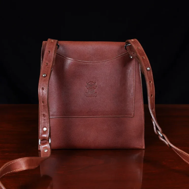 No. 22B Derby Handbag in Vintage Brown on a wood table with a dark background - back view