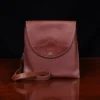 No. 22B Derby Handbag in Vintage Brown on a wood table with a dark background - front view