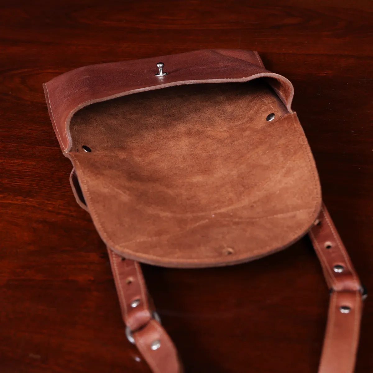 No. 22B Derby Handbag in Vintage Brown on a wood table with a dark background - open view