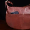 no25 drifter zippered brown leather handbag with pockets - view of phone in pocket