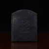 black leather front pocket wallet on wood shelf back