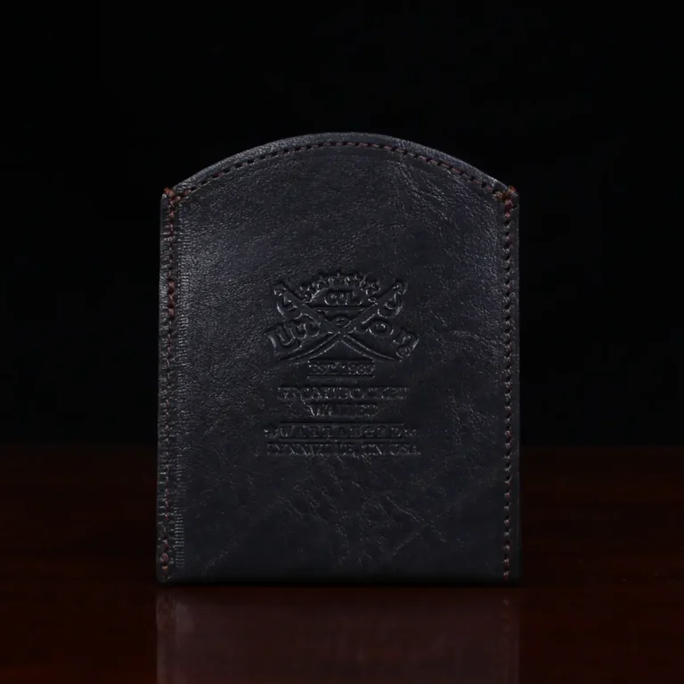 black leather front pocket wallet on wood shelf back