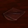 brown leather front pocket wallet on side on wood shelf