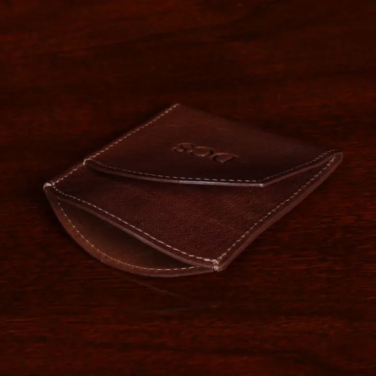 brown leather front pocket wallet on side on wood shelf