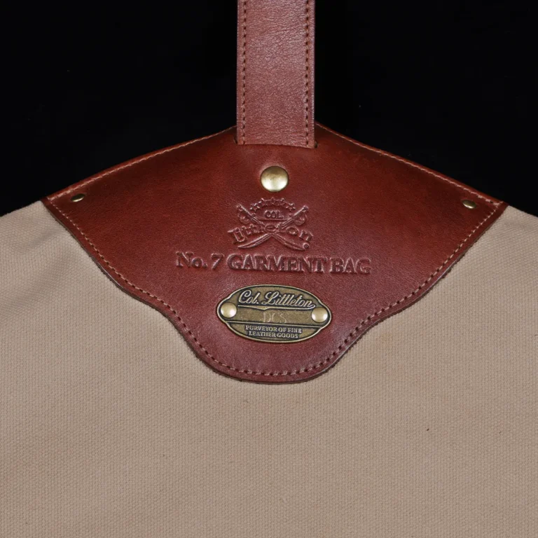 no7 khaki cotton canvas garment bag with brown leather strap - view of logo