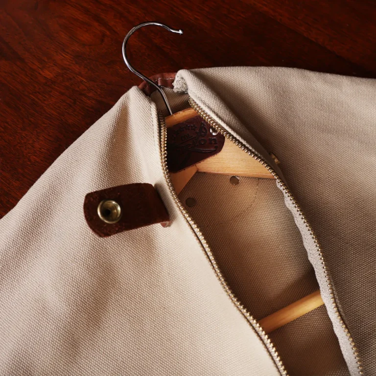 no7 khaki cotton canvas garment bag with brown leather strap open with hanger