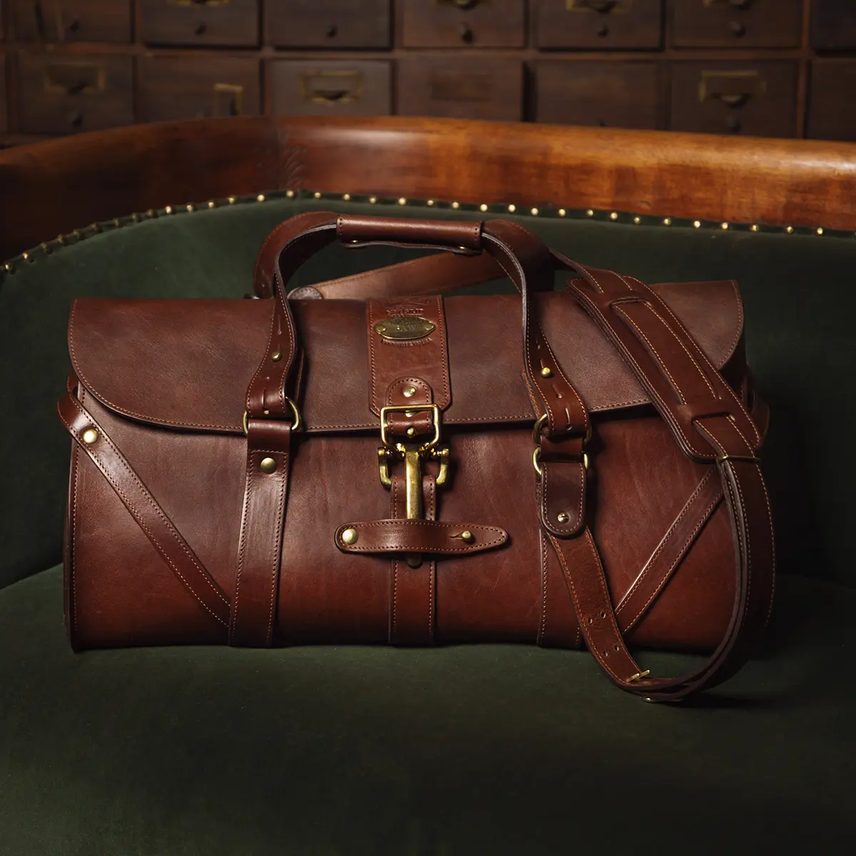 View larger image of leather travel bag on green couch