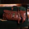 leather travel bag on green couch