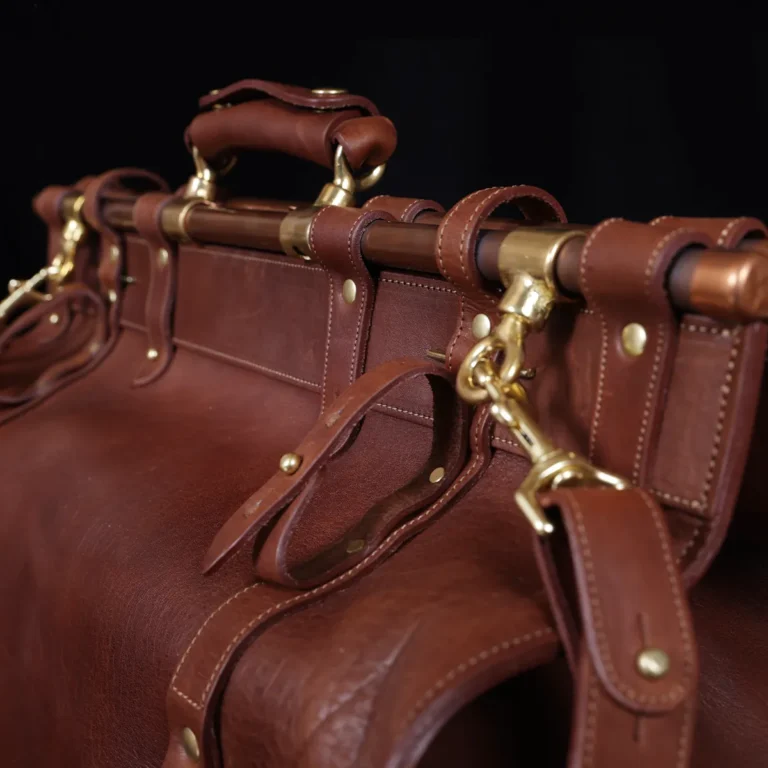 Vintage-style dark brown No. 3 Grip Bag on wooden table with a dark background - view of umbrella holder