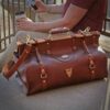 Vintage-style dark brown No. 3 Grip Bag in front of man sitting on outside steps