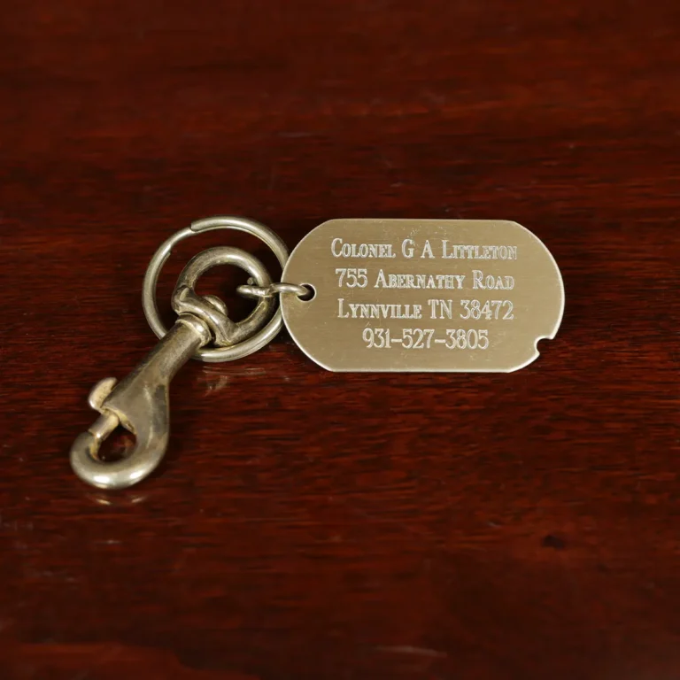 showing the front side of the id luggage tap with colonel littletons engraving