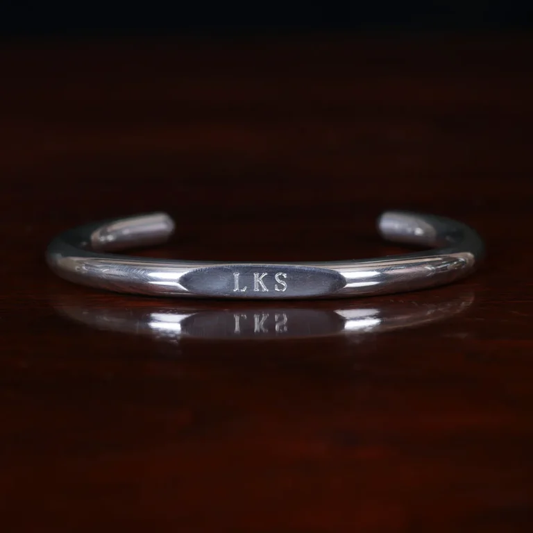 pewter engravable wristwire bracelet on wooden table - front view