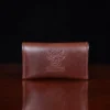 no15 vintage brown american leather pouch on a wooden table with a dark background - back view