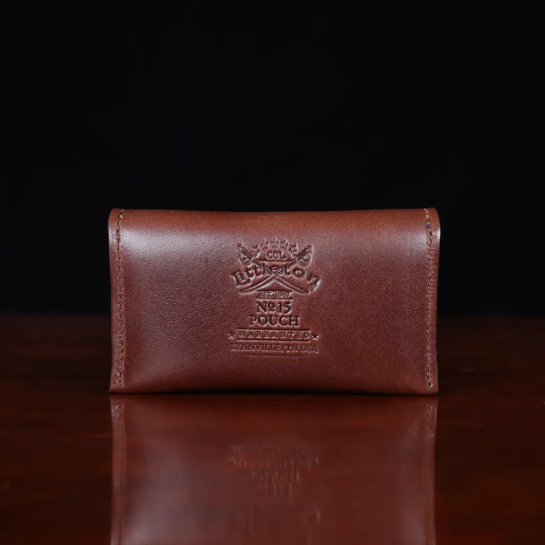 no15 vintage brown american leather pouch on a wooden table with a dark background - back view
