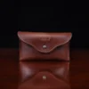 no15 vintage brown american leather pouch on a wooden table with a dark background