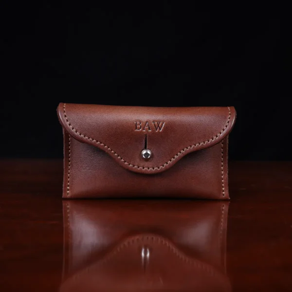 no15 vintage brown american leather pouch on a wooden table with a dark background