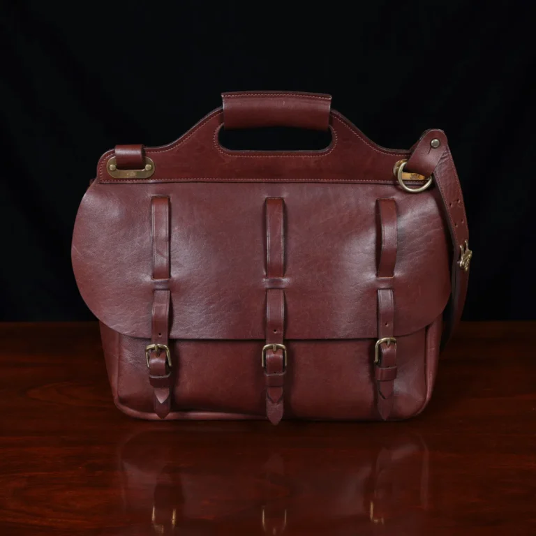 No. 1 Saddlebag Briefcase on a wooden table with a dark background - front view