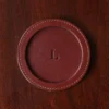 brown round leather coaster on wooden table