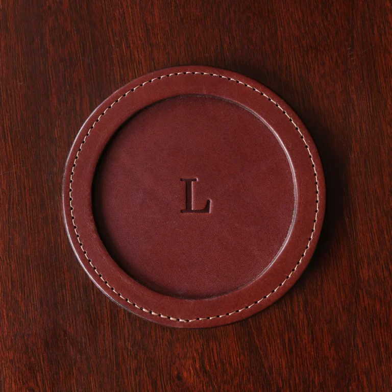 brown round leather coaster on wooden table