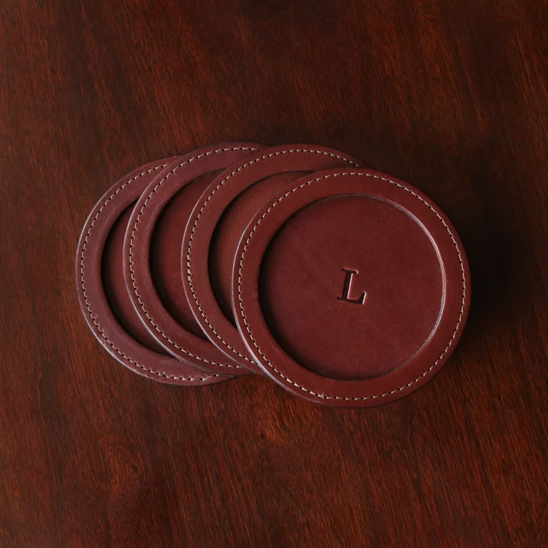 brown round leather coaster set on wooden table