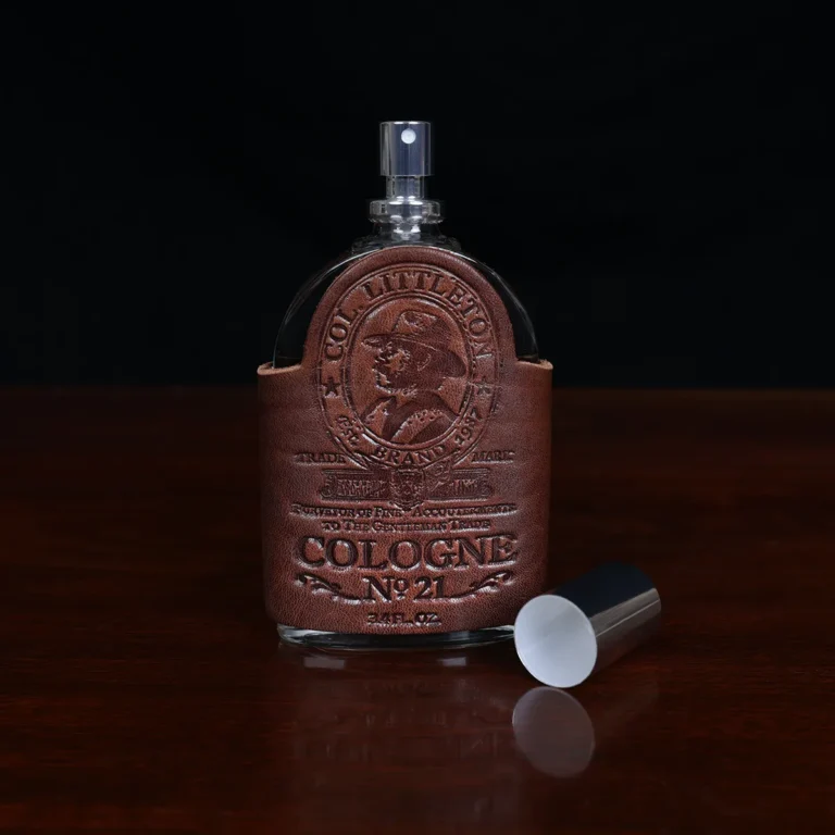 Cologne bottle sitting on wooden table front view with lid