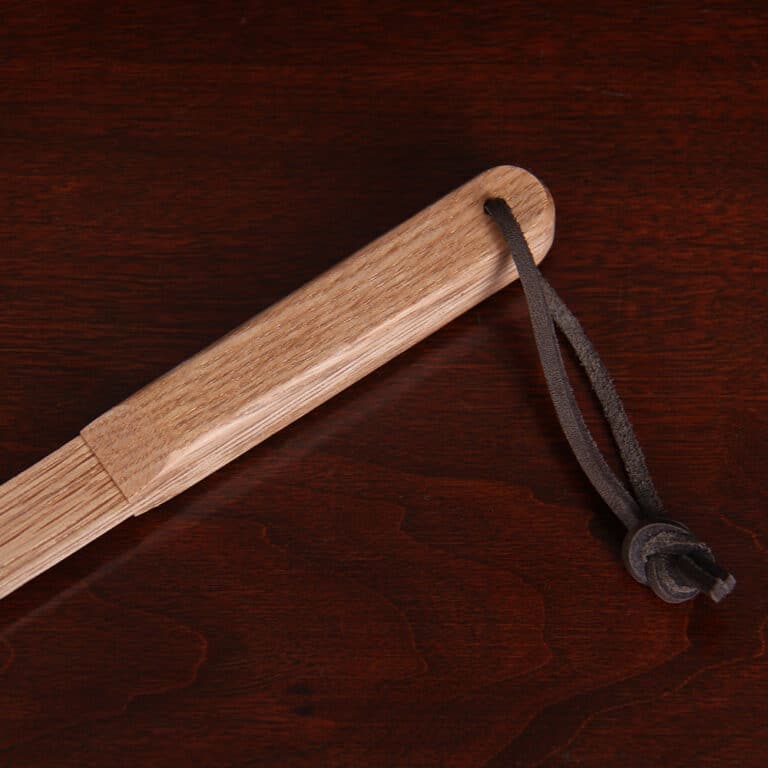 No. 1 Flyswatter in brown American Alligator with a wooden handle - detail view of the end of the handle