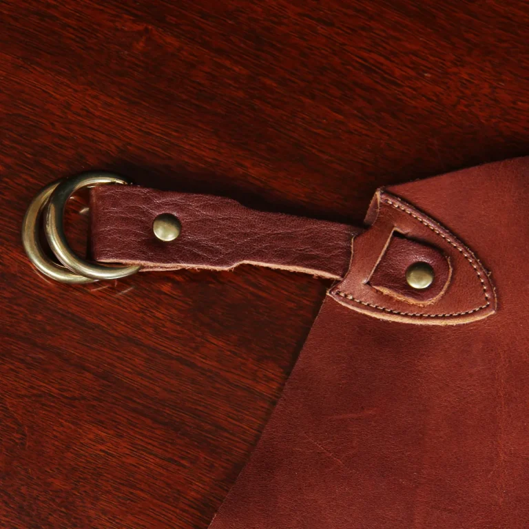 leather apron - on wooden table - view of hook