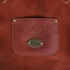 leather apron - on wooden table - view of small front pocket with personaliztion