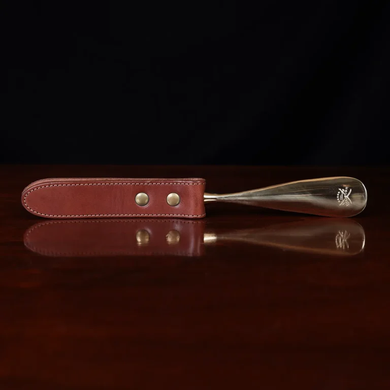 no2 shoehorn with personalization plate on a wooden table with a dark background - back view