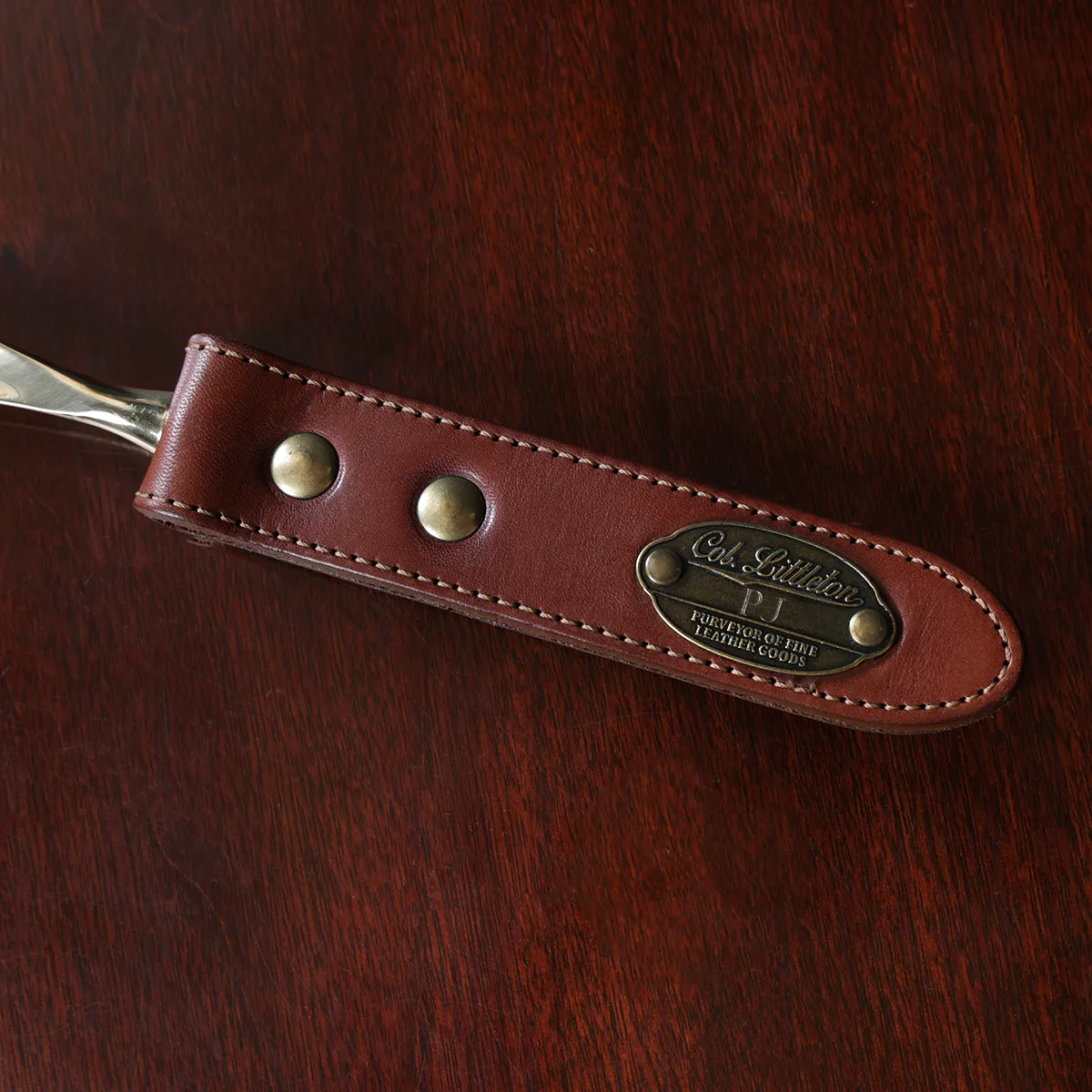 no2 shoehorn with personalization plate on a wooden table - view of handle