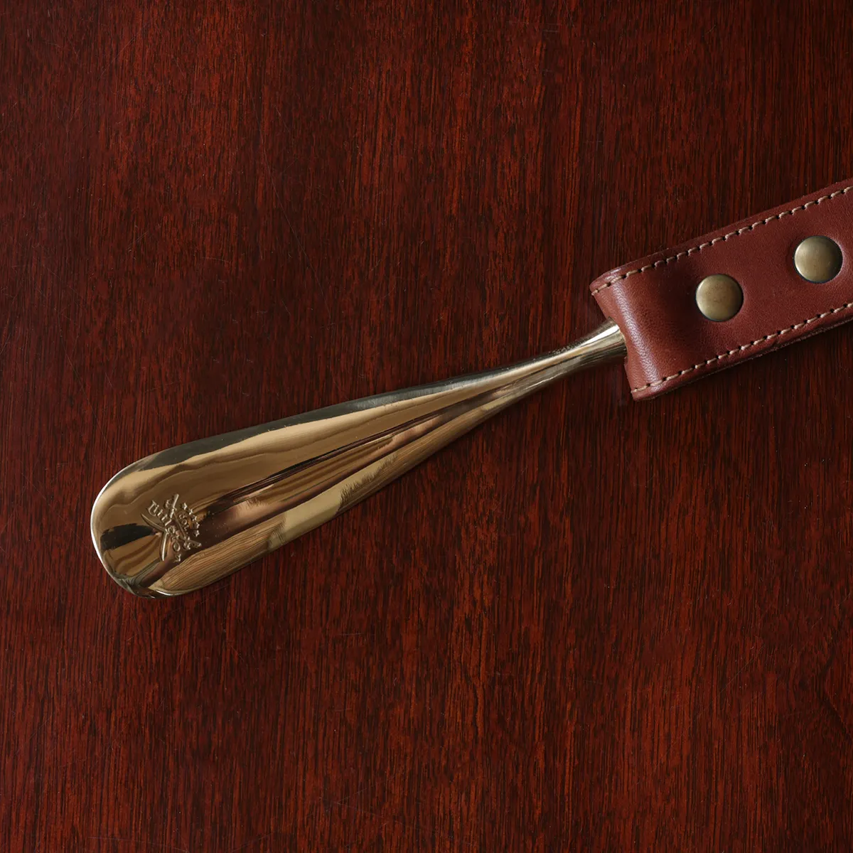 no2 shoehorn with personalization plate on a wooden table