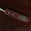 no2 shoehorn with personalization plate on a wooden table with a dark background