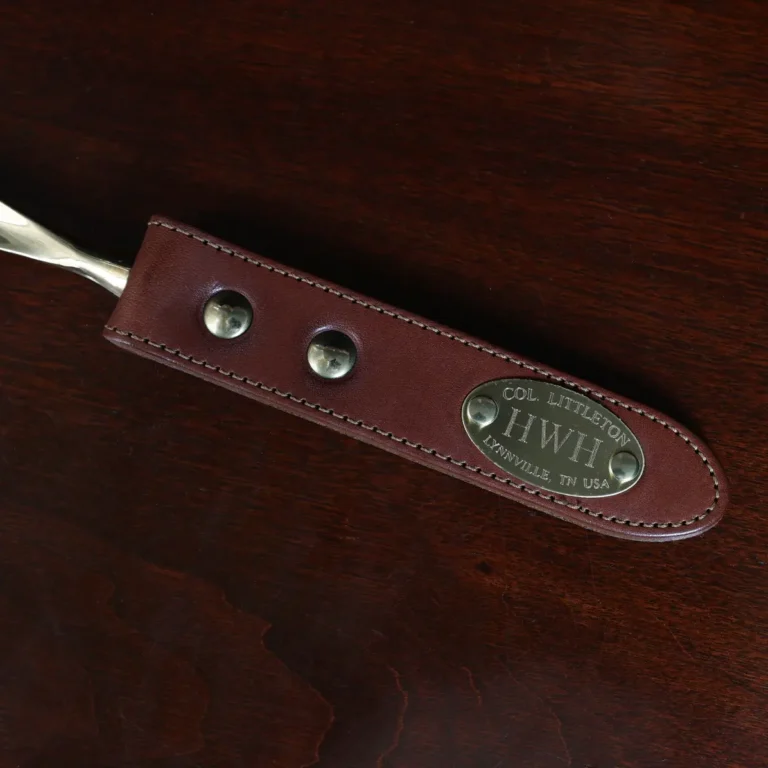 no2 shoehorn with personalization plate on a wooden table with a dark background