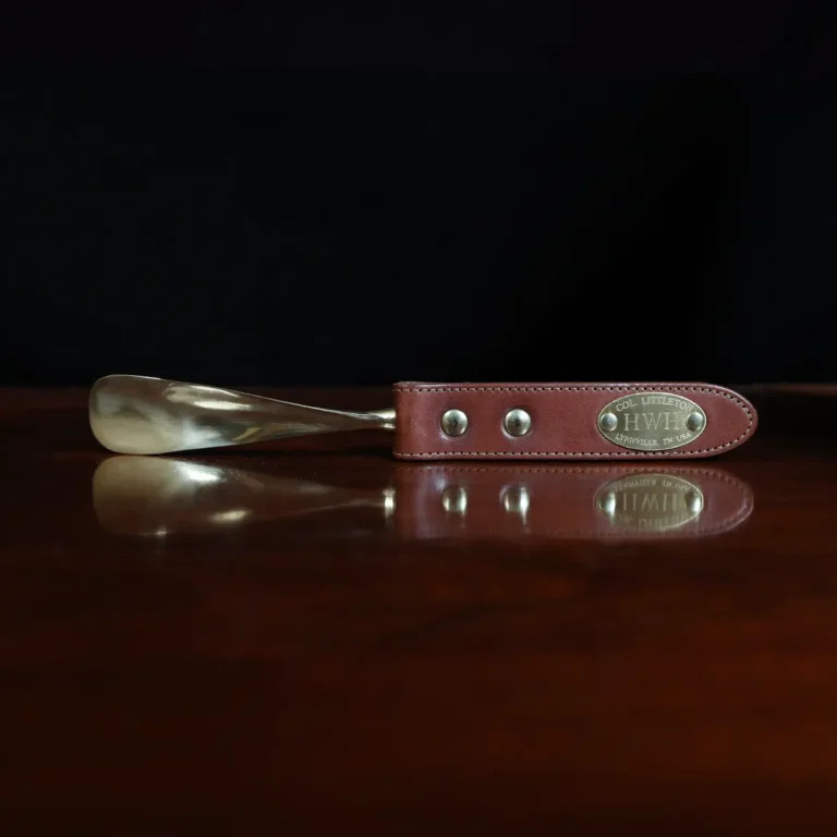 no2 shoehorn with personalization plate on a wooden table with a dark background