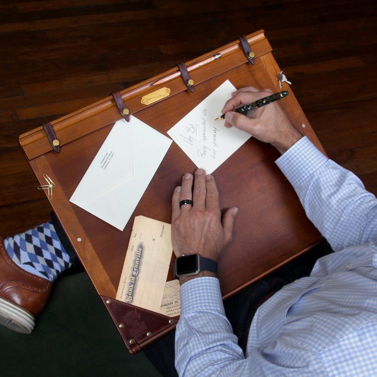 man writing on 10 american cherry wood and leather writing board