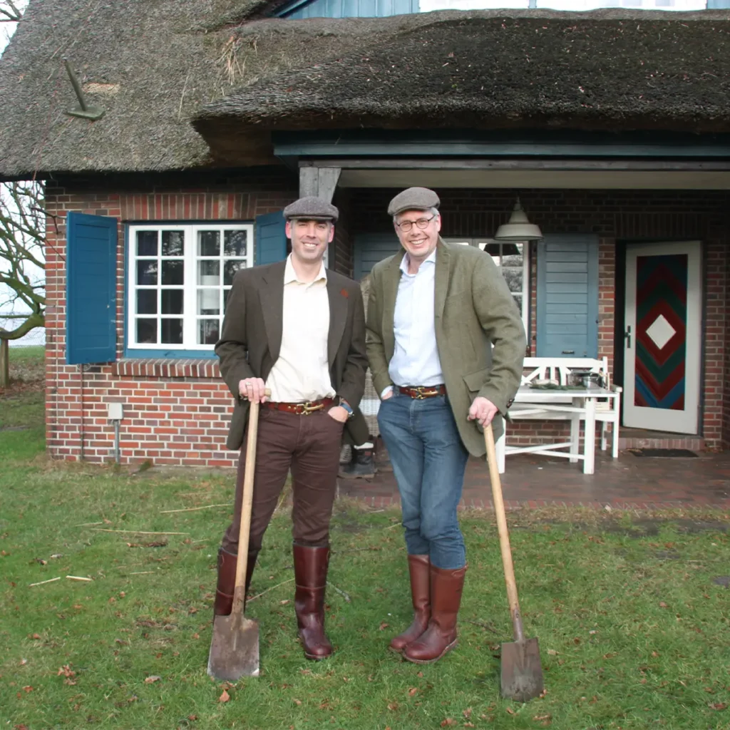 All In the Family 2 two men wearing No. 5 Cinch Belt holding shovels outside