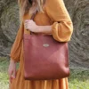 women wearing a no. 9b tote in a hay field