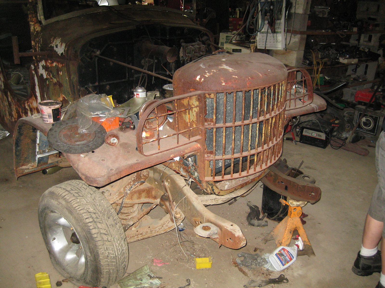 Extremely rusted front grill and body of a 1941 Army Command Car.