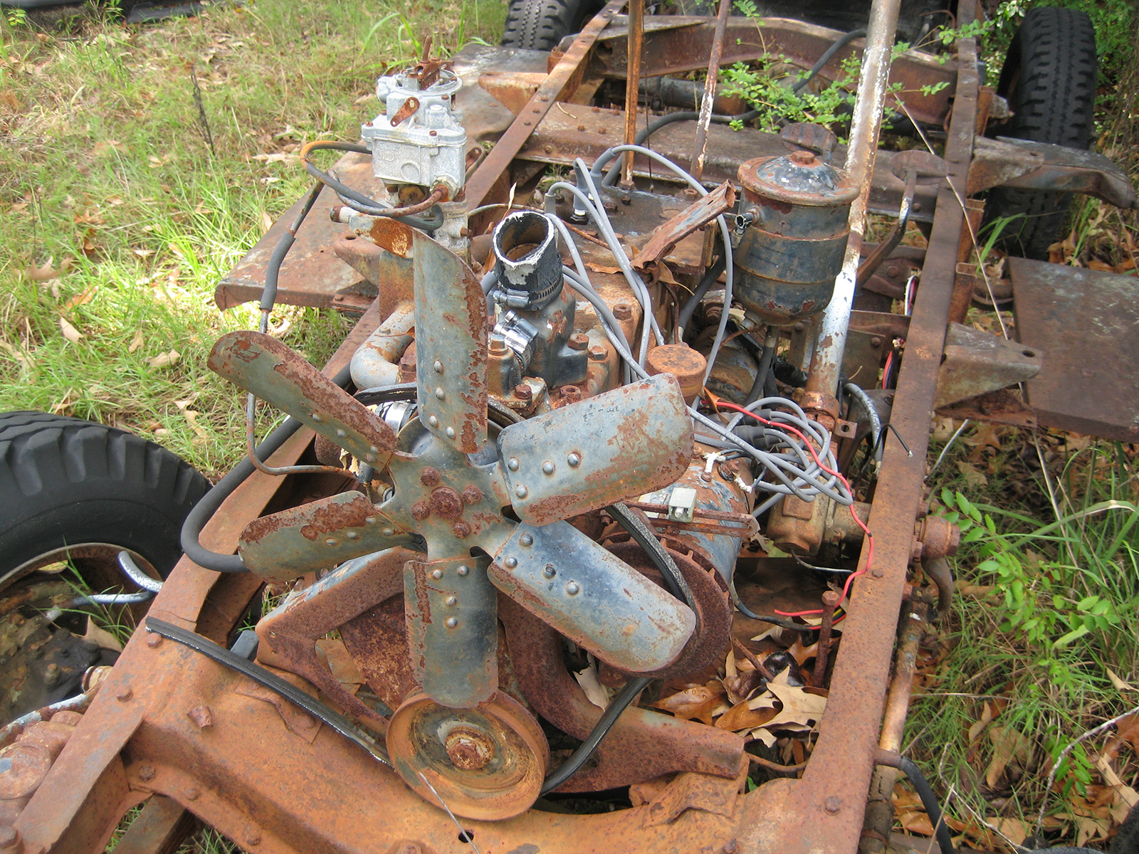 Very rusted engine block and chassis of 1941 Army Command Car.