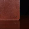 no 28 leather pocket journal on a wooden table with a dark background - front view of personalization