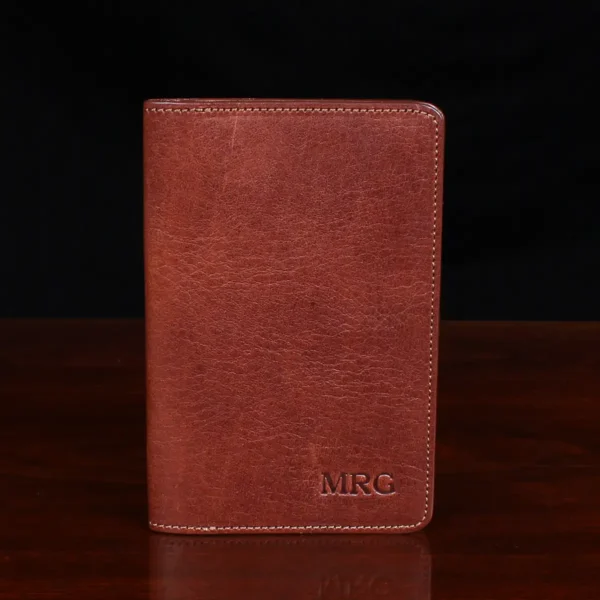 no27 vintage brown passport wallet front view with black background