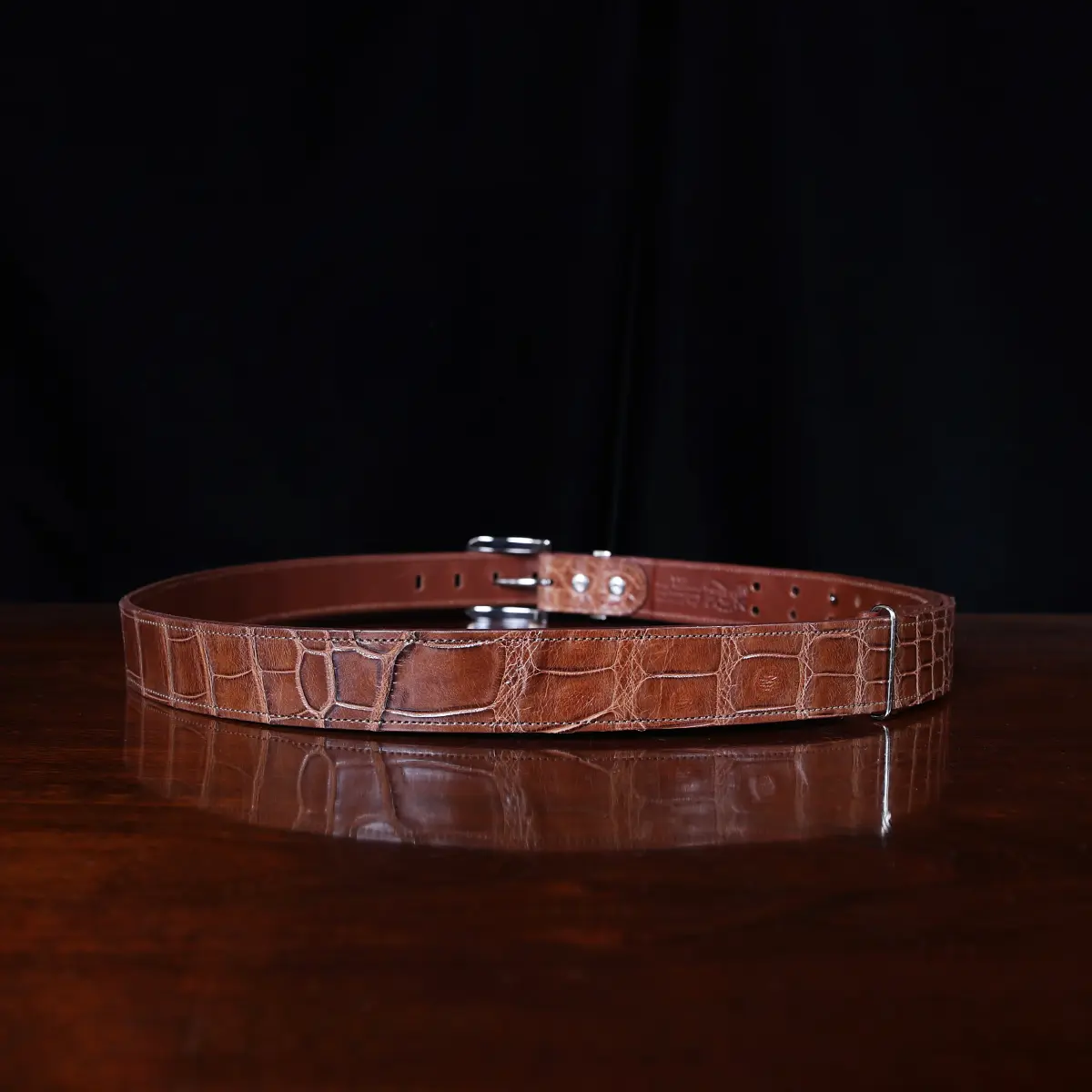 No. 4 Belt in American Alligator - X-Large - ID 001 - back view on a wooden table with black background